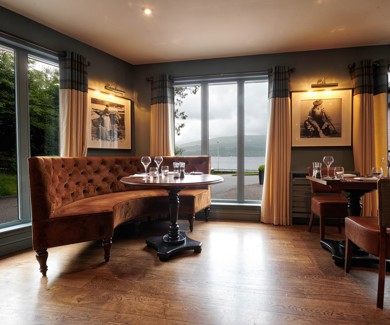 Elegant restaurant seating with large windows overlooking Loch Fyne at an Inveraray hotel and spa, one of the best restaurants in Inveraray. ?? ''